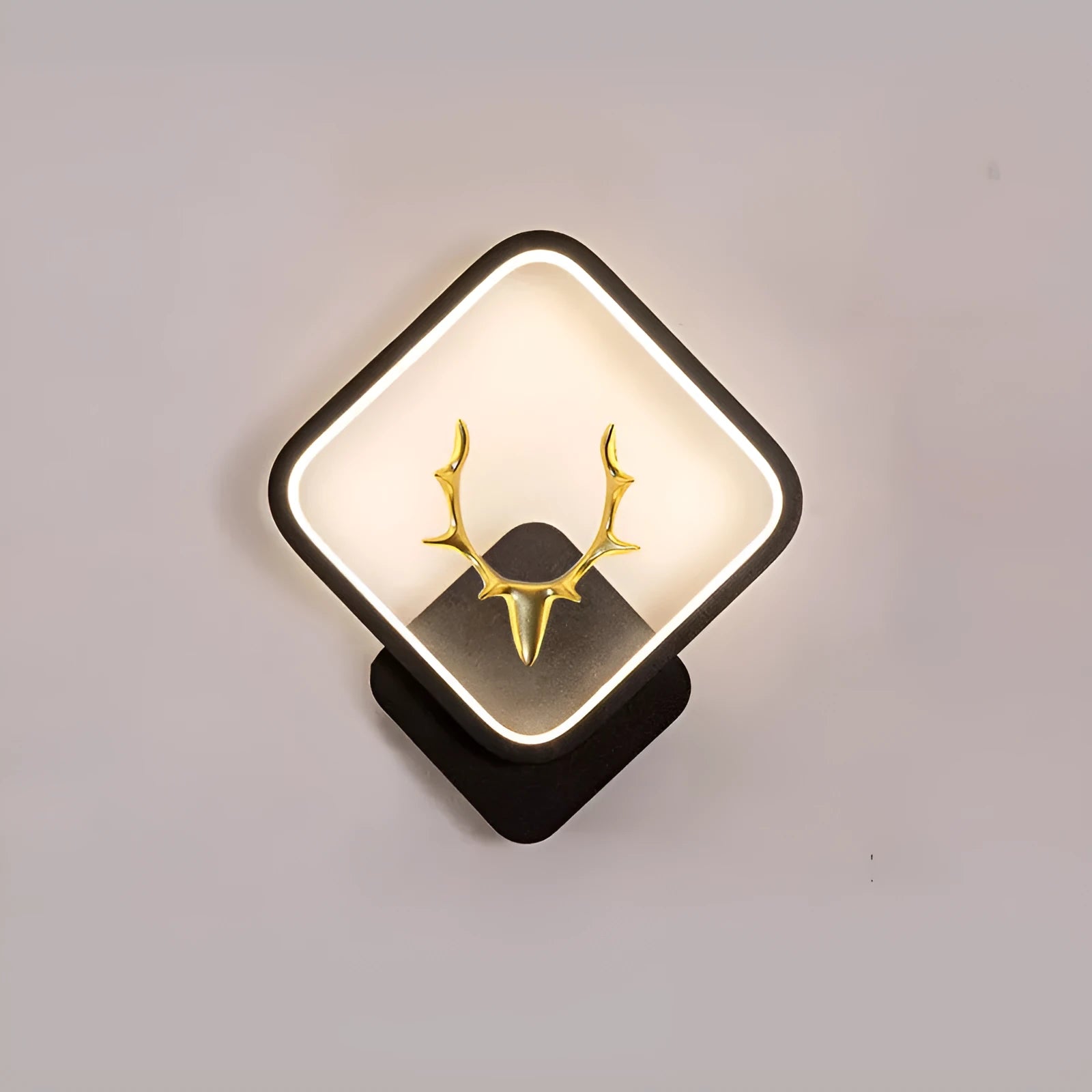 Deer antler shaped wall light with remote control on a plain wall, showing white and black colour options.