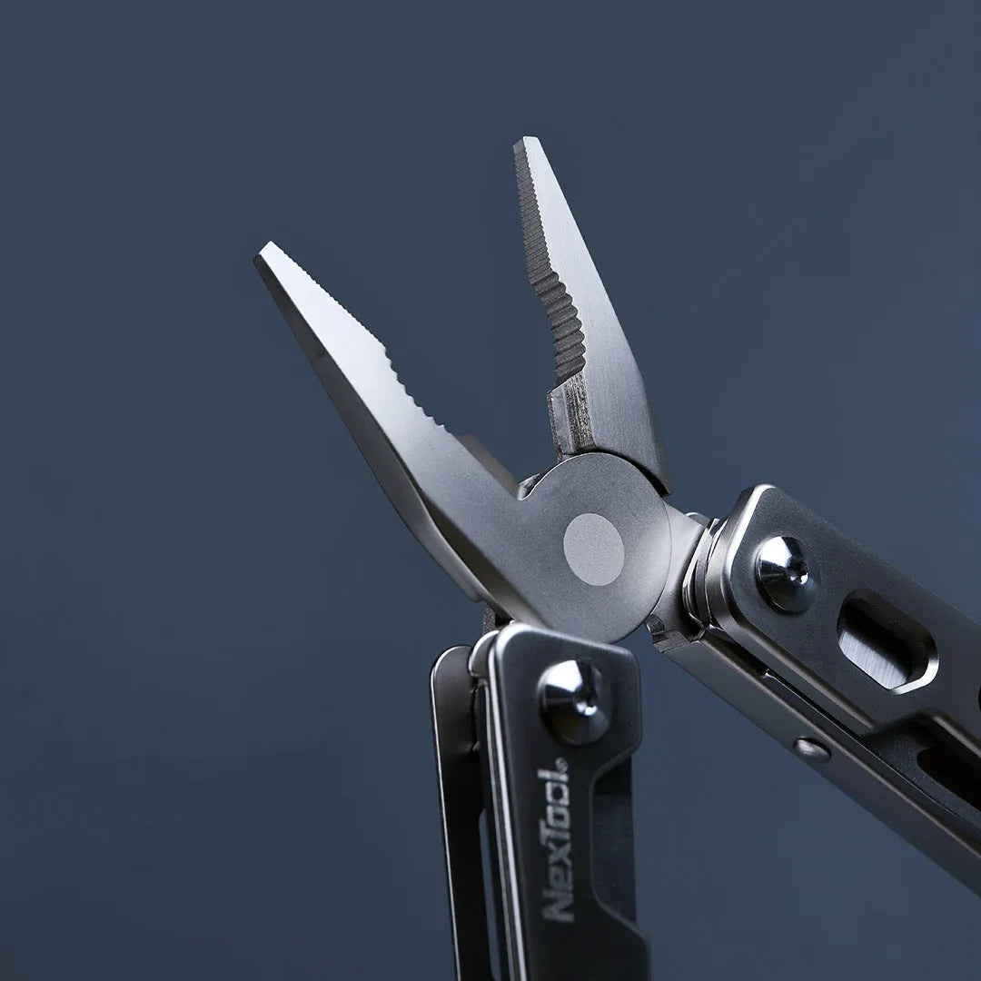 White stainless steel multi-function tool with wrench, knife blade, and needle nose pliers