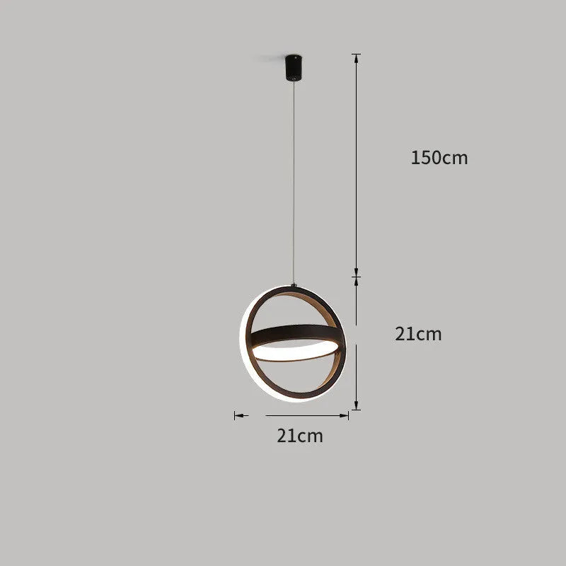 Modern black iron bedside lamp with a square shade and remote control on a wooden table.