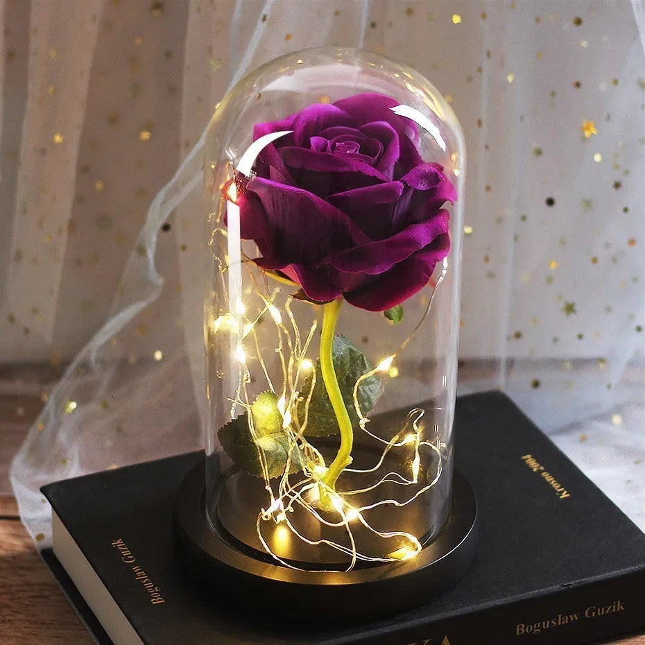 Simulated scarlet rose LED bouquet glowing inside a glass dome on a wooden base.