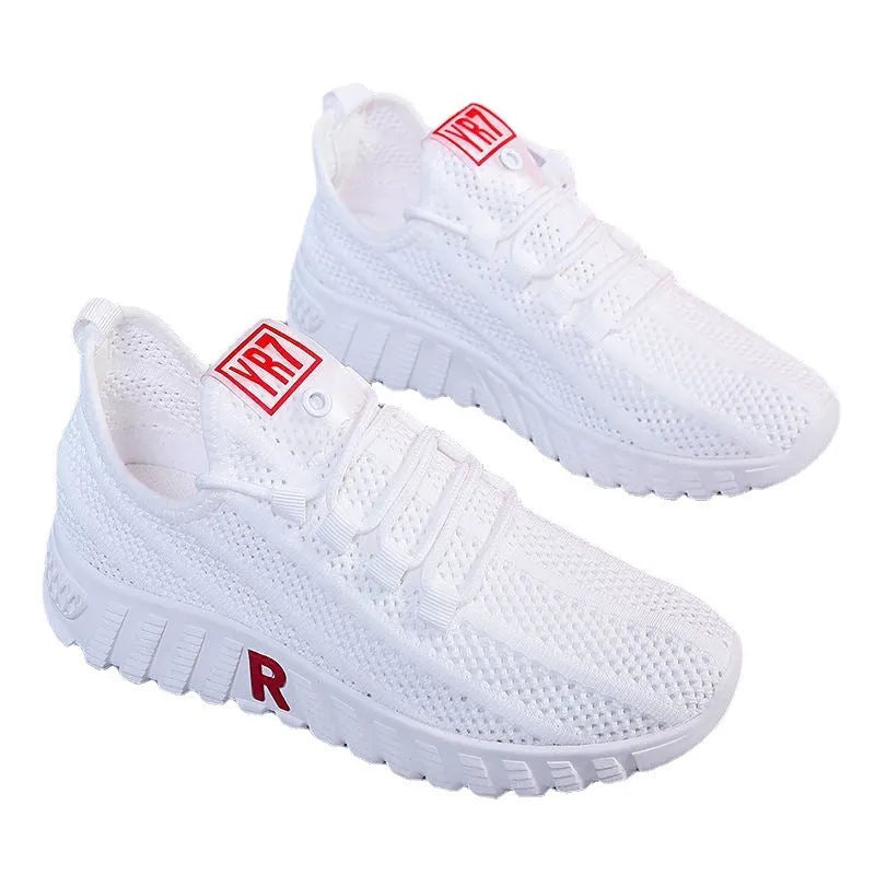 Women's white canvas sports casual shoes with rubber sole, round toe, and low heel, side view