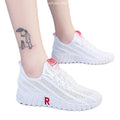 Women's white canvas sports casual shoes with rubber sole, round toe, and low heel, side view