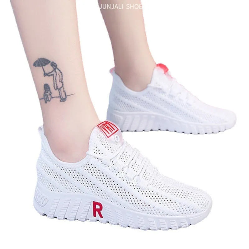 Women's white canvas sports casual shoes with rubber sole, round toe, and low heel, side view