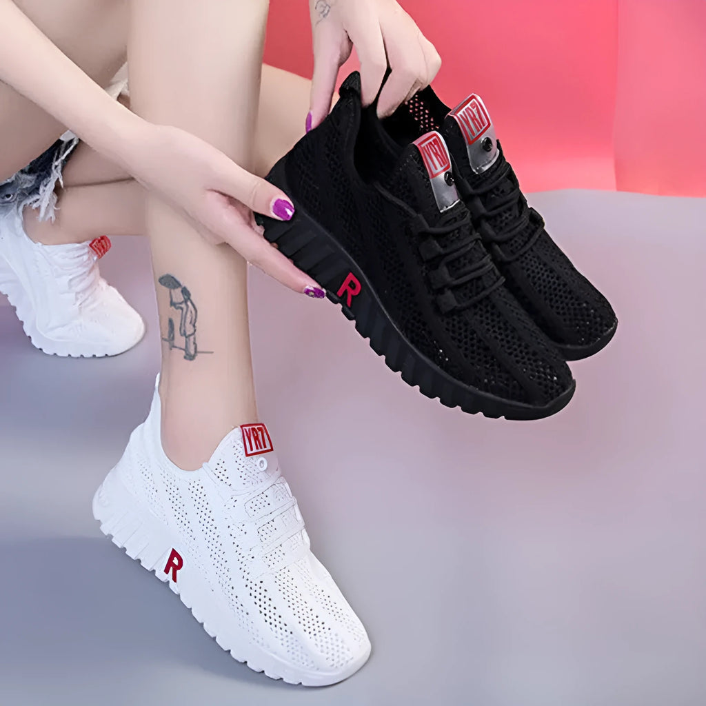 Women's white canvas sports casual shoes with rubber sole, round toe, and low heel, side view