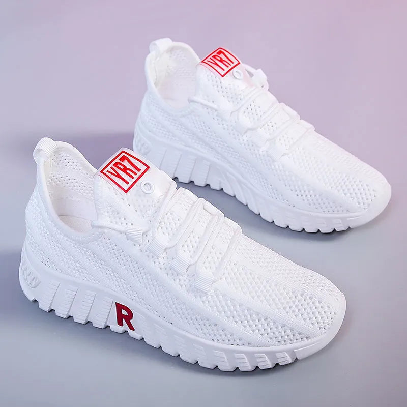 Women's white canvas sports casual shoes with rubber sole, round toe, and low heel, side view