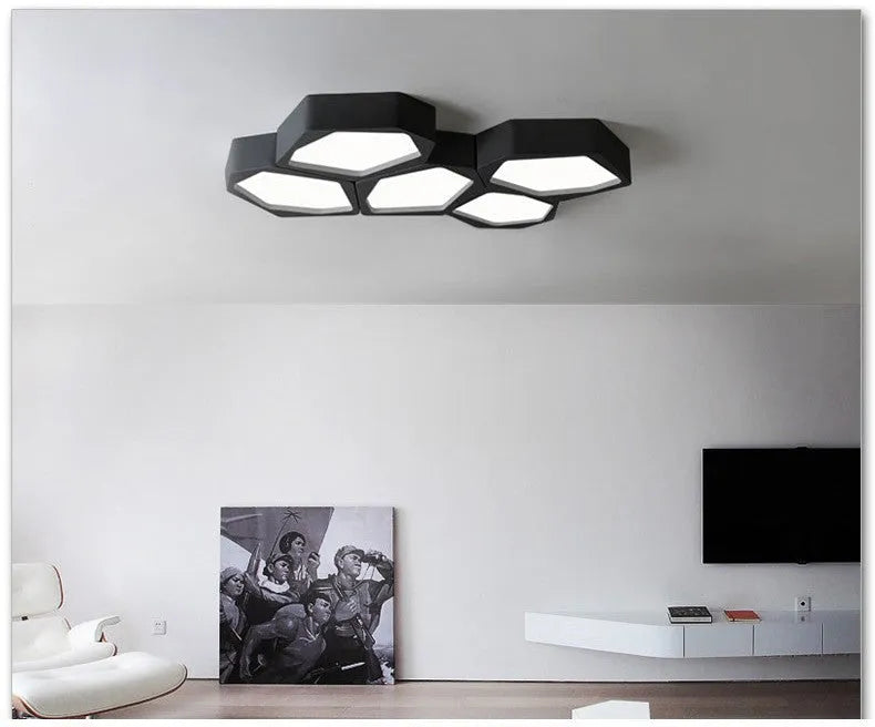 Geometric shaped LED wall light in black frame with three colour modes for living room or bedroom