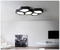 Geometric shaped LED wall light in black frame with three colour modes for living room or bedroom