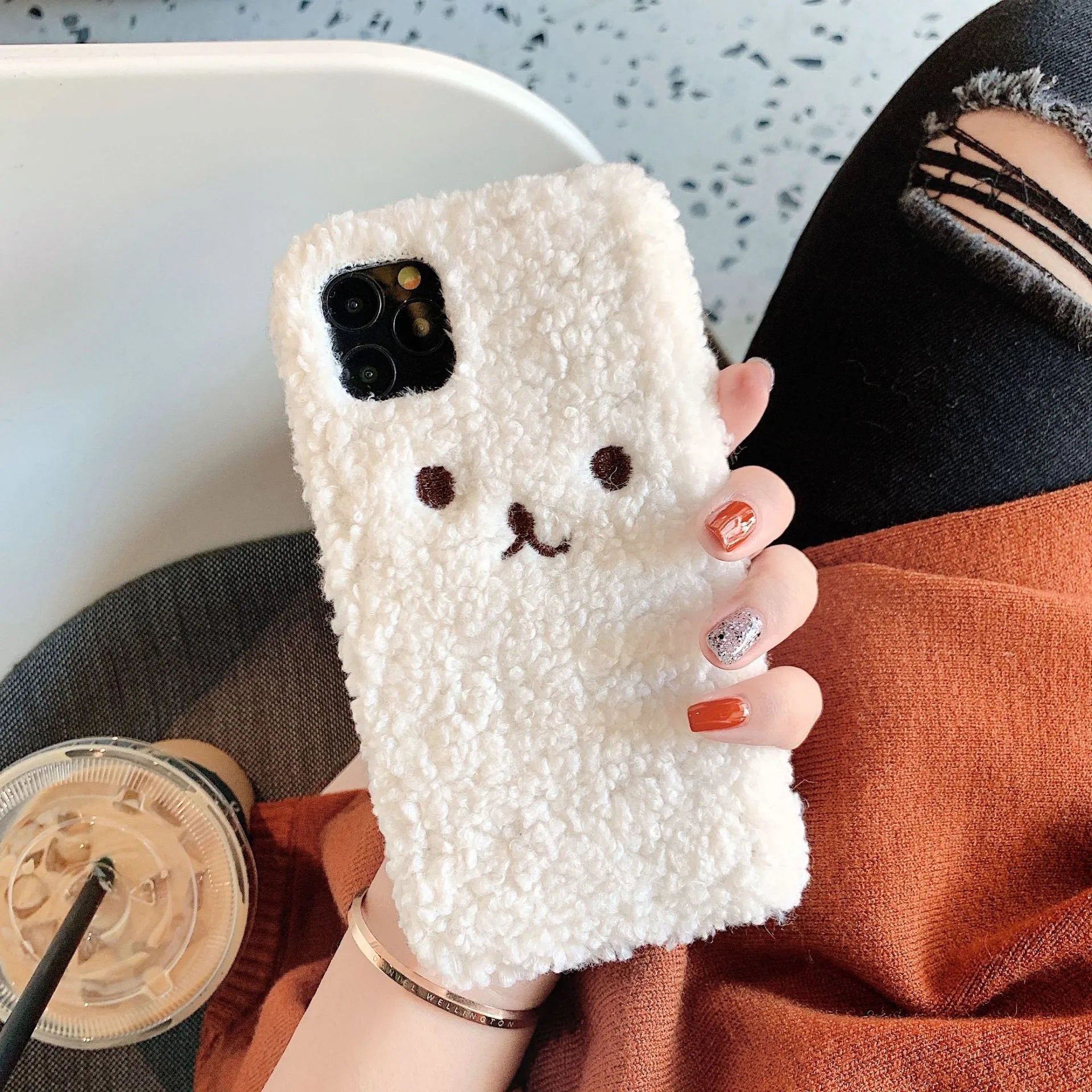 Embroidered brown plush bear cartoon design on a white TPU iPhone case for iPhone 11.