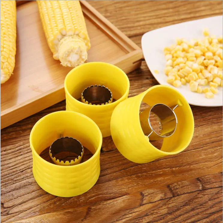 Yellow manual corn thresher kitchen tool with a corn-kernel-shaped plastic handle.