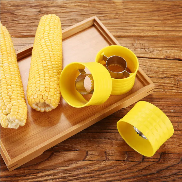 Yellow manual corn thresher kitchen tool with a corn-kernel-shaped plastic handle.