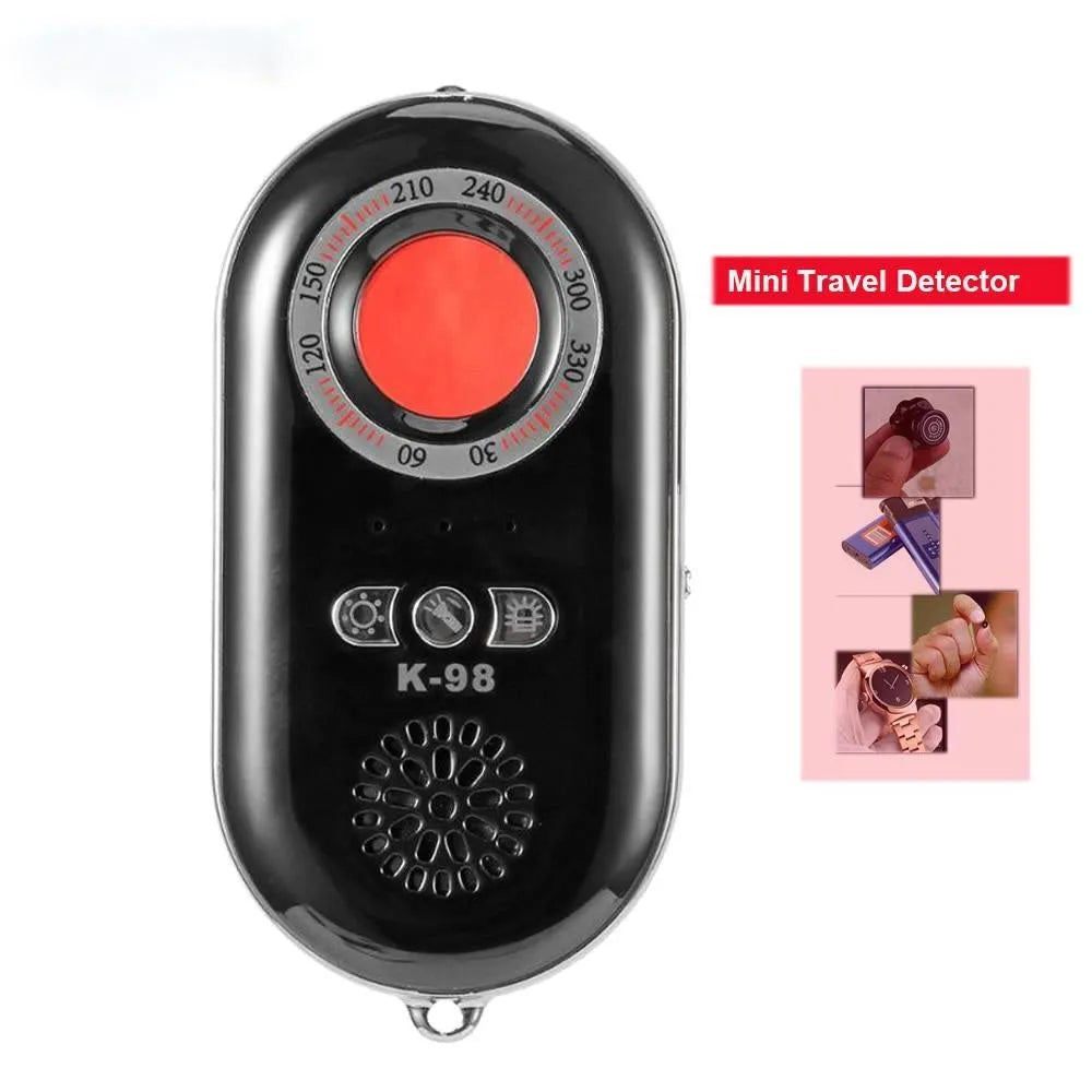 Compact black wireless signal detector and anti-theft alarm with vibration sensor, shown next to a ruler for scale.
