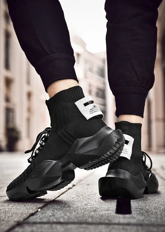 Men's black and white casual sports shoes with mesh lining, shown in large sizes.