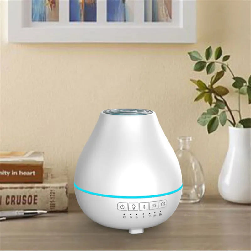 White circular Bluetooth humidifier and aroma diffuser with night light on a wooden surface.