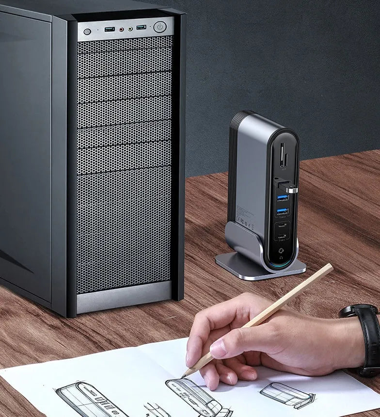 Deep space grey 16-in-1 USB-C docking station hub with multiple ports and external power supply on a desk.