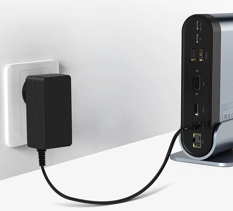 Deep space grey 16-in-1 USB-C docking station hub with multiple ports and external power supply on a desk.