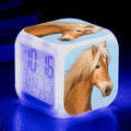 Square cartoon LED digital alarm clock showing time, temperature, and weekday on luminous display.
