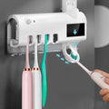 Black wall-mounted UV toothbrush steriliser with automatic toothpaste dispenser and solar panel.