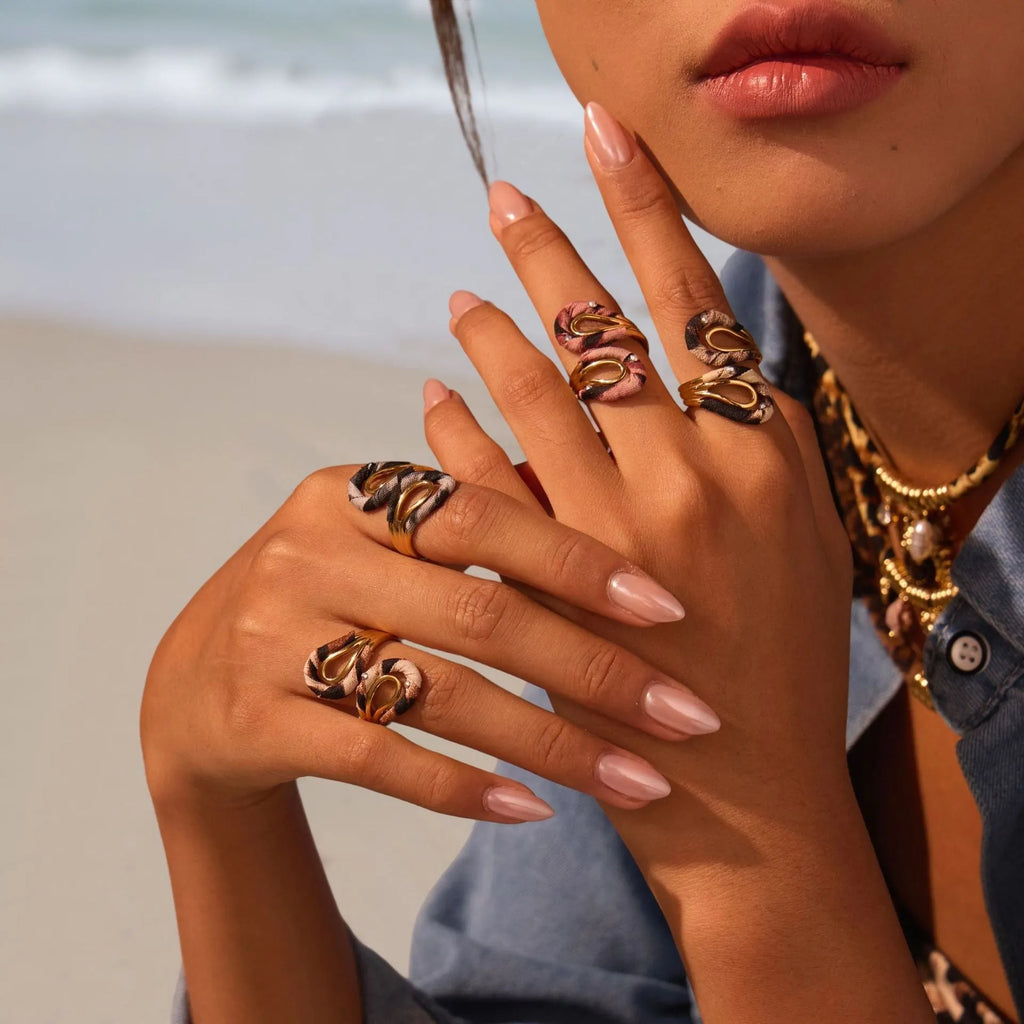 Leopard print stainless steel open mouth ring showing heart, star and geometric shapes.