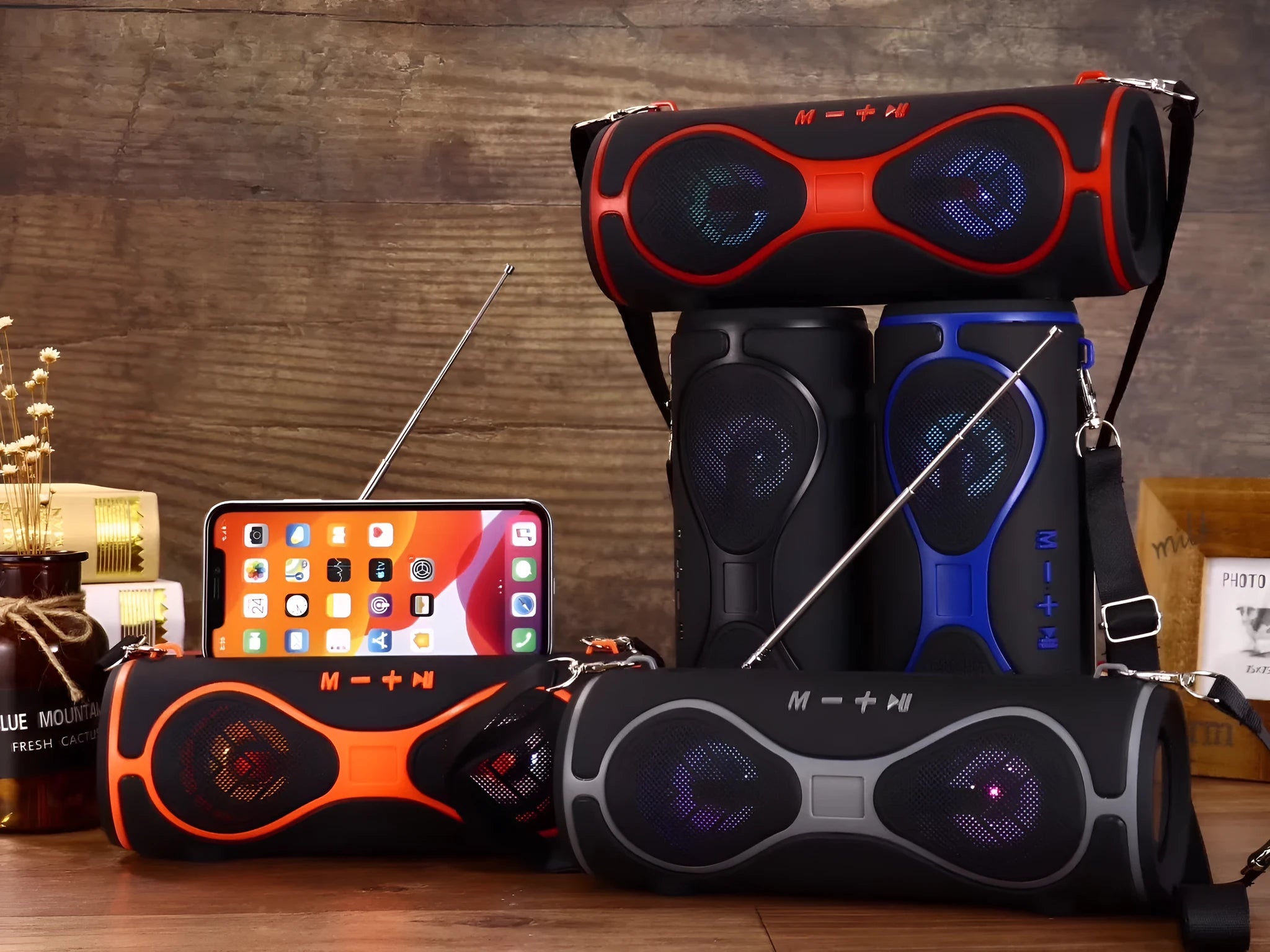 Portable lantern-style Bluetooth speaker with shoulder strap and integrated mobile phone stand in multiple colour options