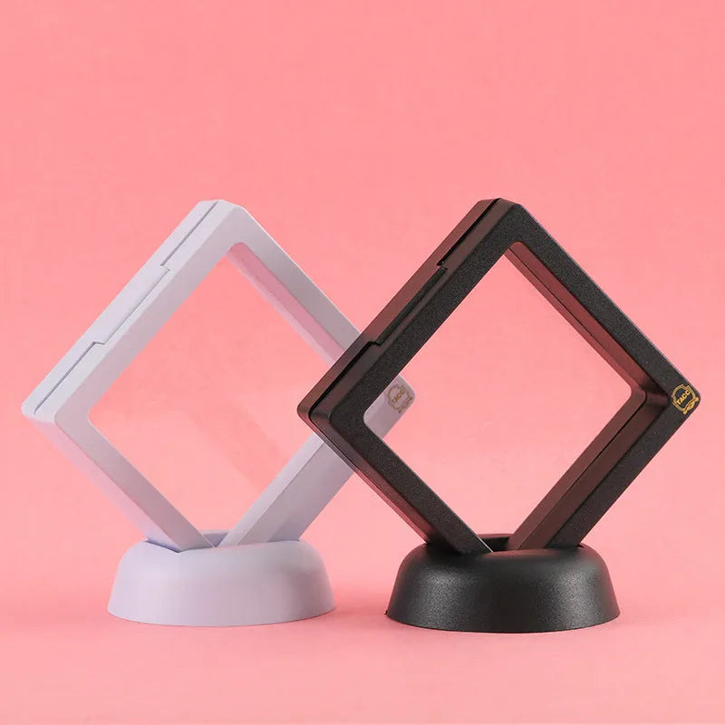 Transparent 3D floating display case holding a coin, with black and white size options