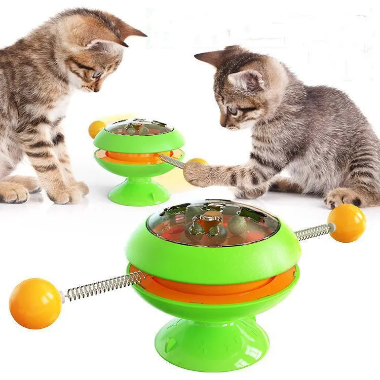 Rotating turntable cat toy with transparent catnip compartment and suction cup base