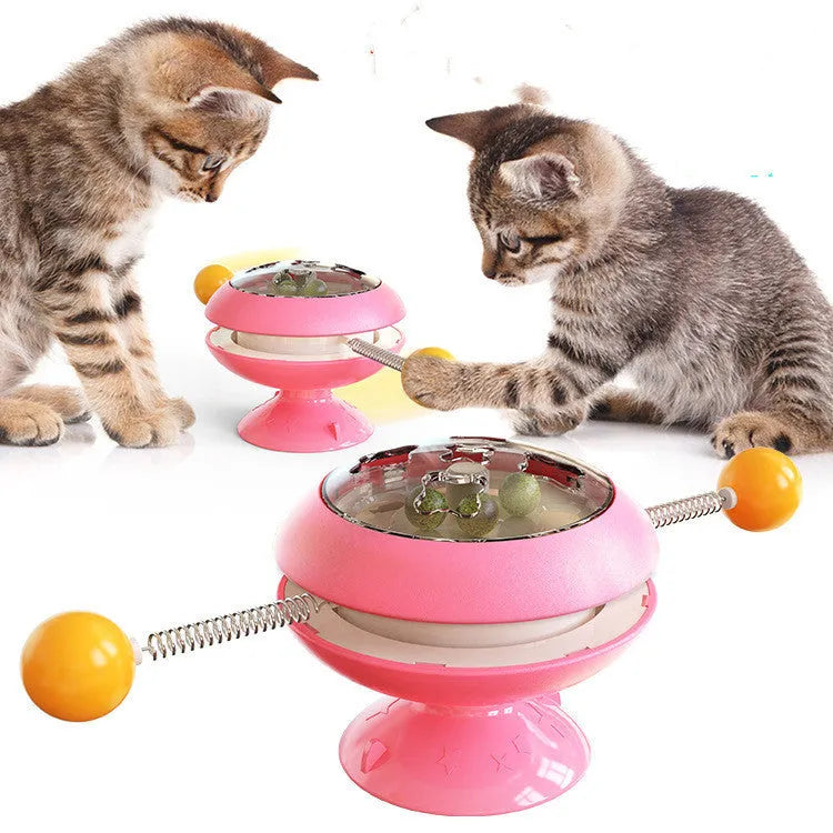 Rotating turntable cat toy with transparent catnip compartment and suction cup base