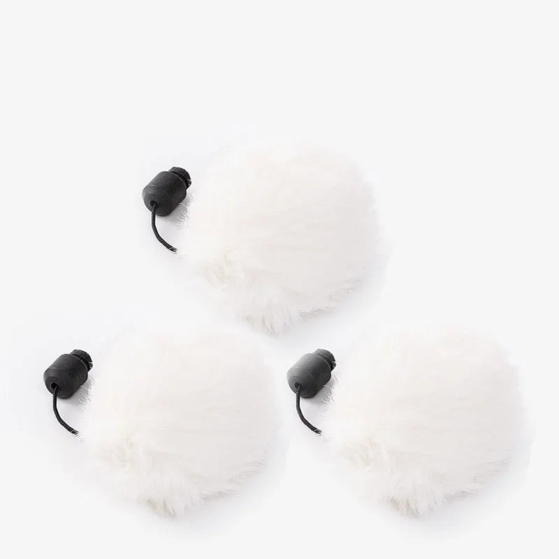 White automatic funny cat toy with swinging rabbit fur ball teaser on a floor