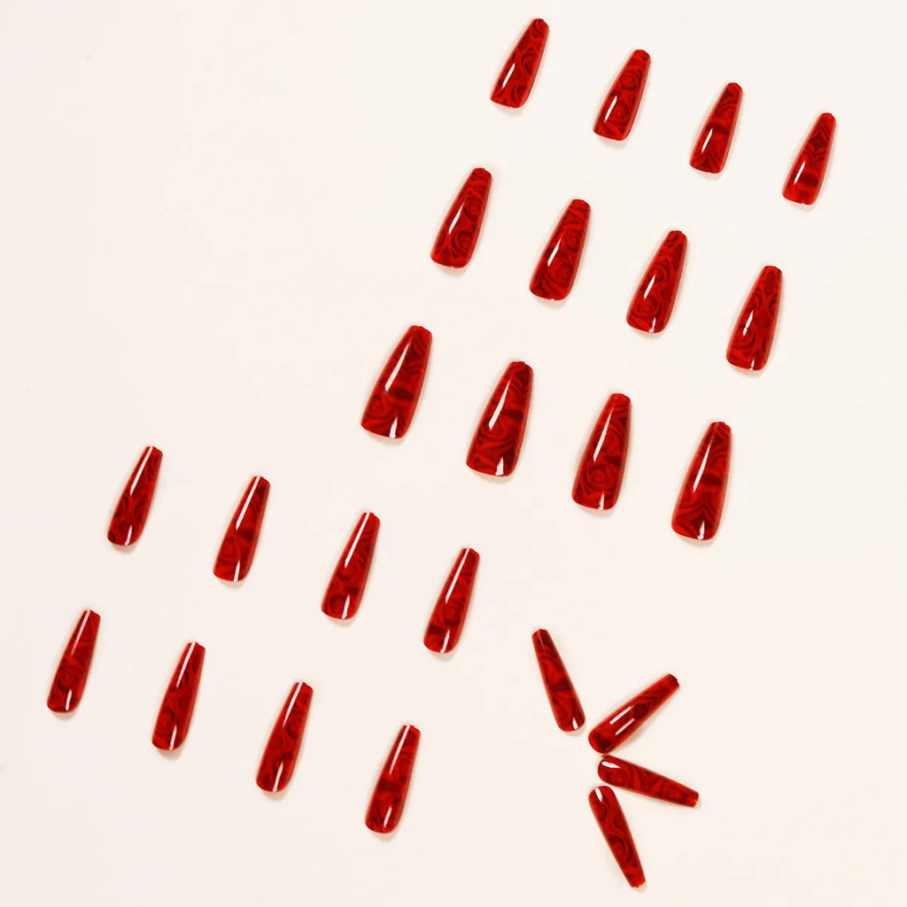 Hot wine red rose wearing nail art finished product set with 24 tablets and glue on white background