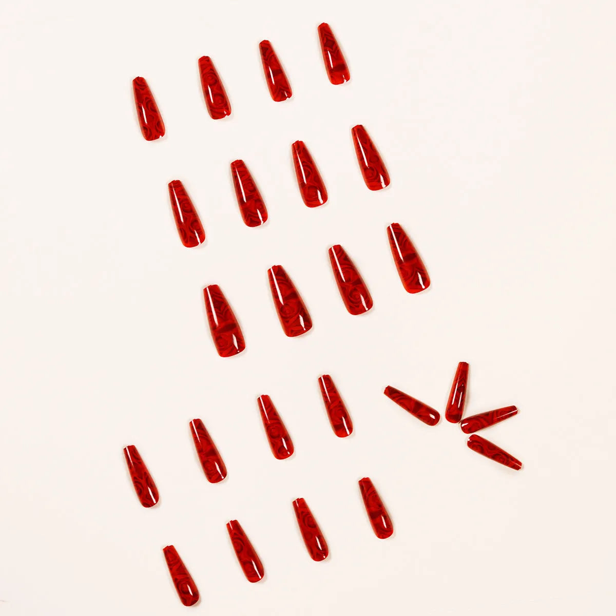 Hot wine red rose wearing nail art finished product set with 24 tablets and glue on white background