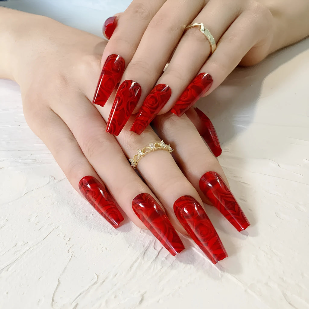 Hot wine red rose wearing nail art finished product set with 24 tablets and glue on white background