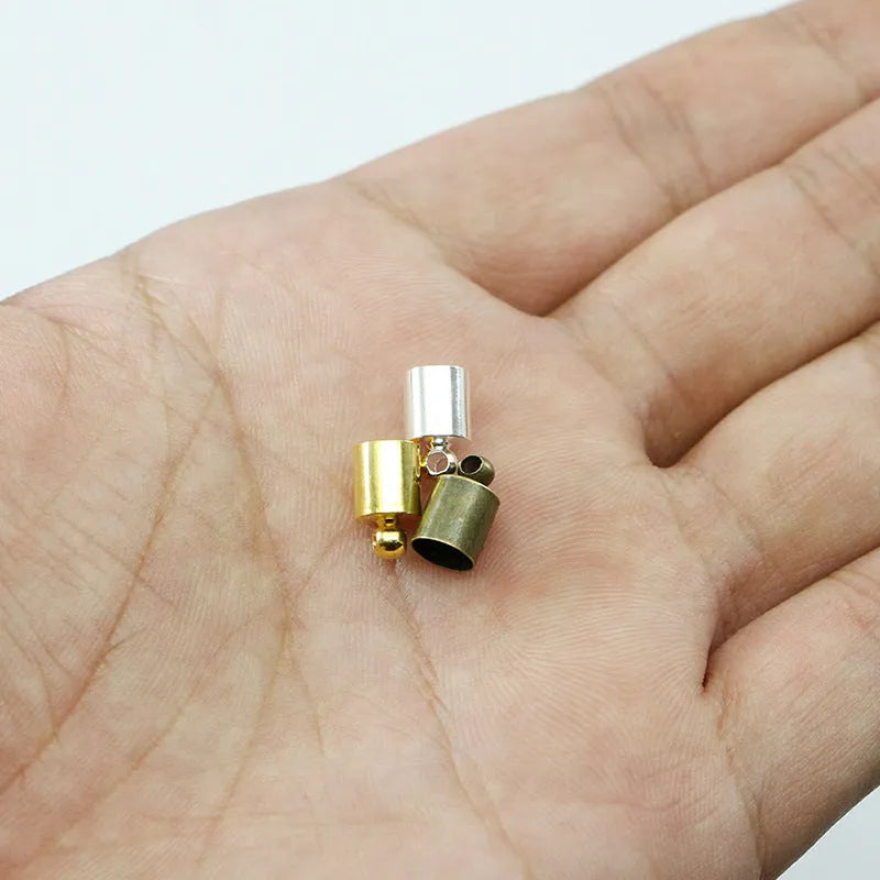 Assorted copper caps in gold, silver, black, and bronze finishes for jewellery making