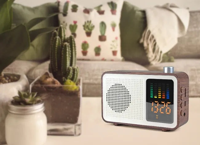 Brown retro Bluetooth speaker with FM radio, fabric grill, and telescopic antenna