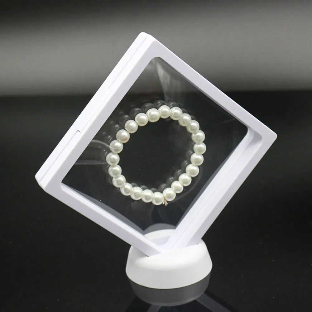 Transparent 3D floating display case holding a coin, with black and white size options