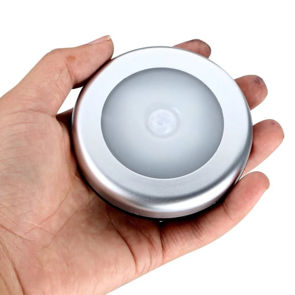 Silver round wireless motion sensor night light with compact 80mm diameter design for cupboards and hallways.