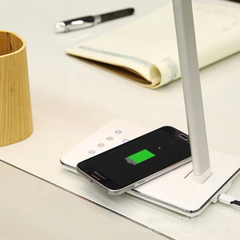 Wireless charging desk lamp with touch control in black finish on a bedside table