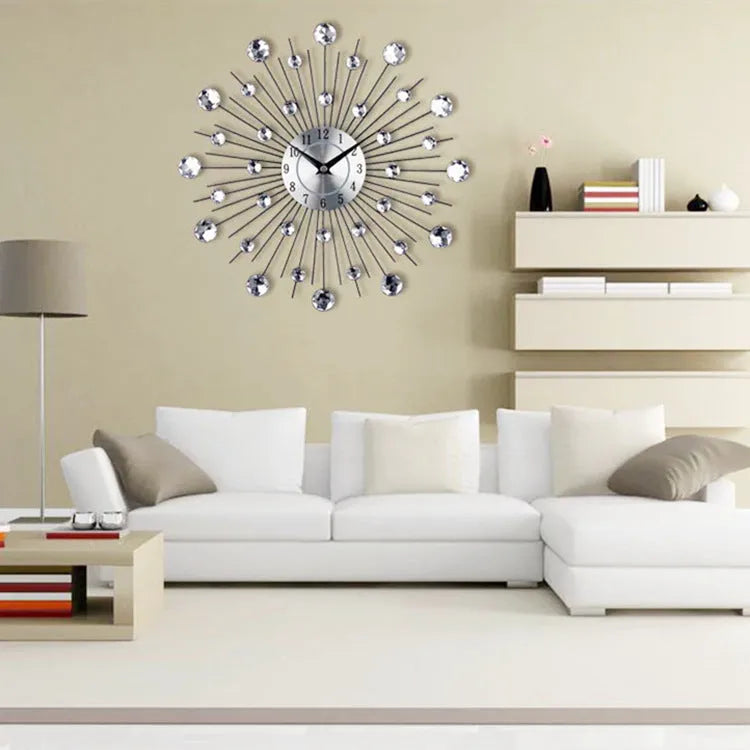 Large round silver wall clock with numbers and metal frame on a wall.