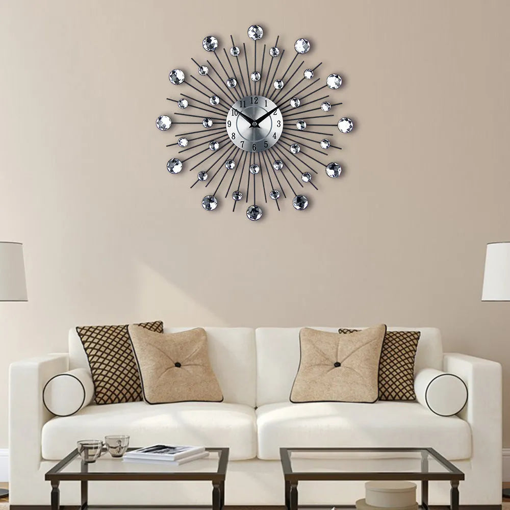 Large round silver wall clock with numbers and metal frame on a wall.