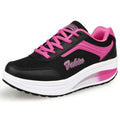 Women's grey pink heelless travel shoes with a middle heel on a plain background