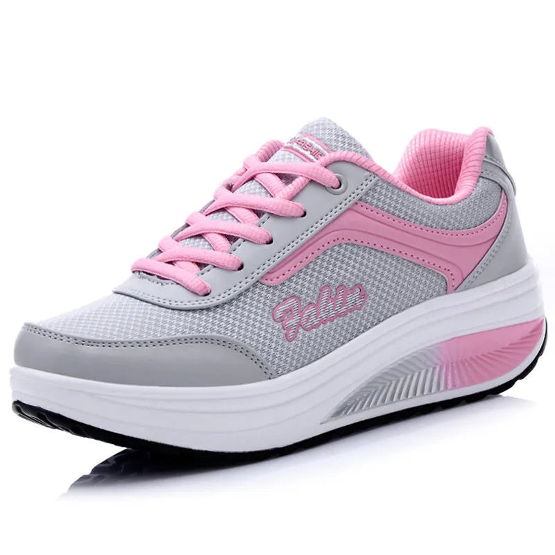 Women's grey pink heelless travel shoes with a middle heel on a plain background