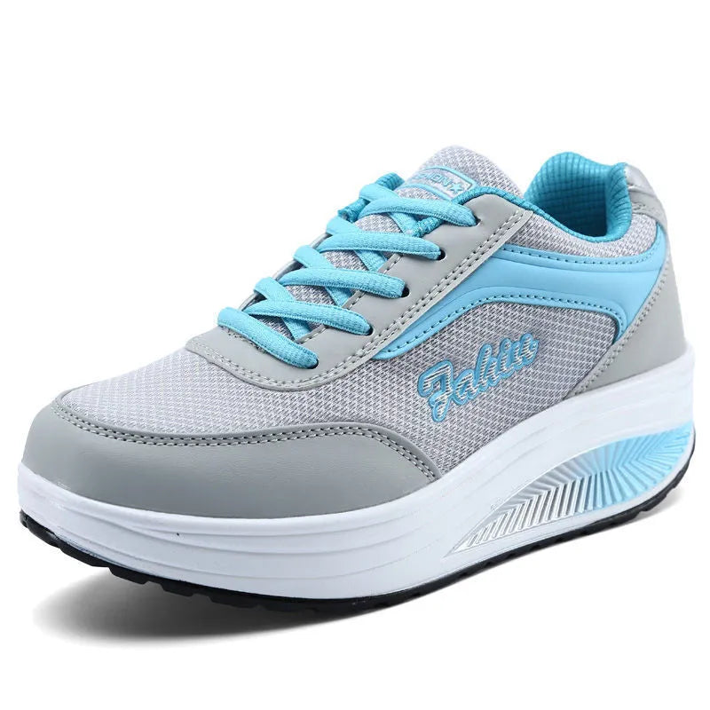 Women's grey pink heelless travel shoes with a middle heel on a plain background