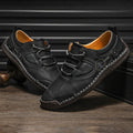 Men's black microfiber leather casual shoes with round toe on a plain background