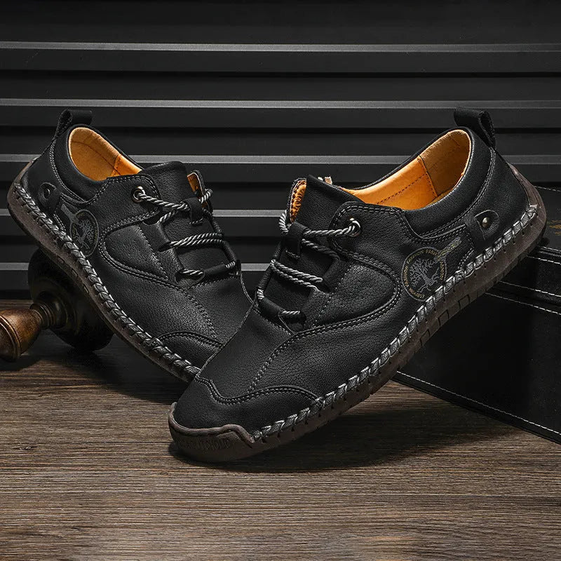 Men's black microfiber leather casual shoes with round toe on a plain background