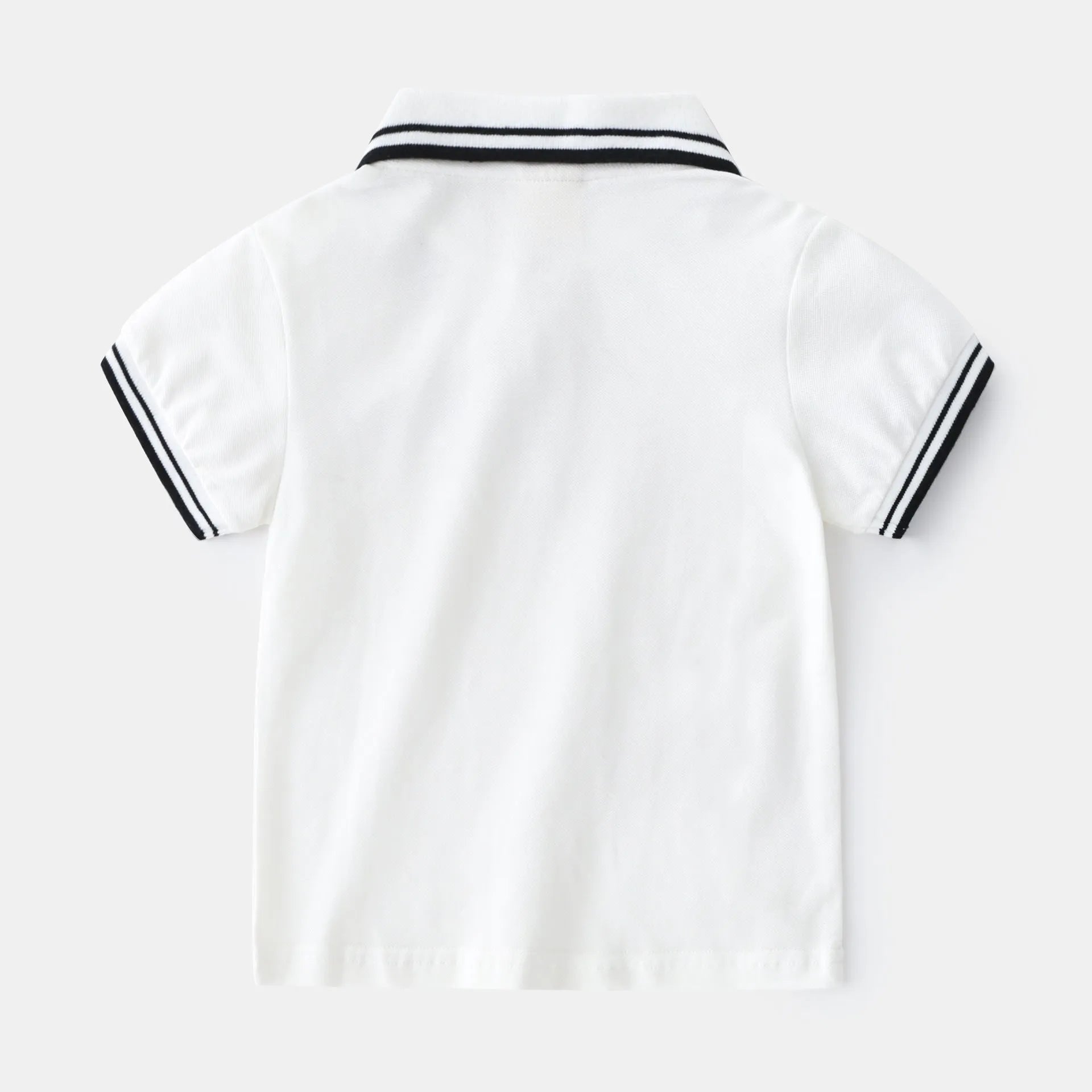 Boys short sleeve cotton polo shirt in white or black, sized for children 90cm to 130cm tall.