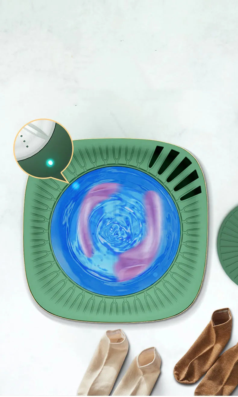 Green portable mini automatic washing machine for underwear and travel on a white surface.