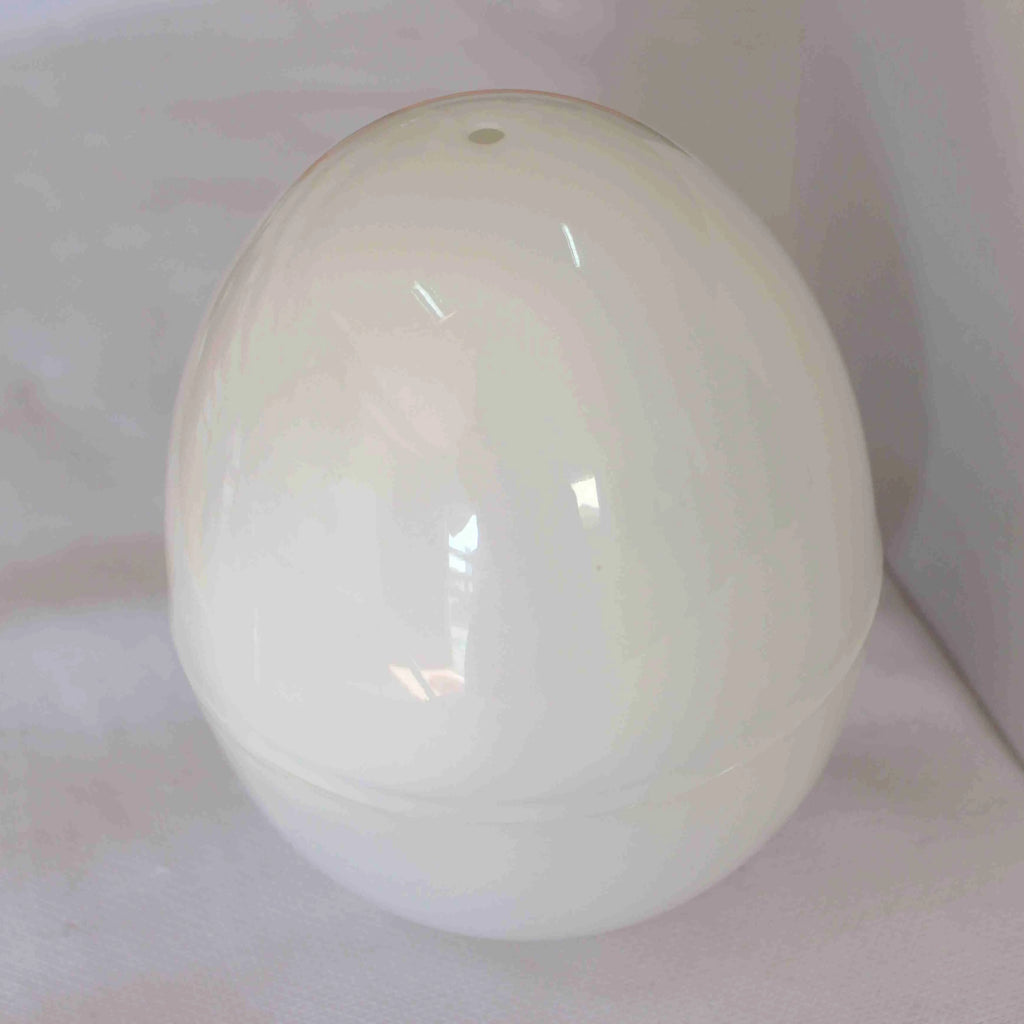 White microwave egg steamer in egg shape with lid, holds up to 4 eggs for hard or soft boiled cooking