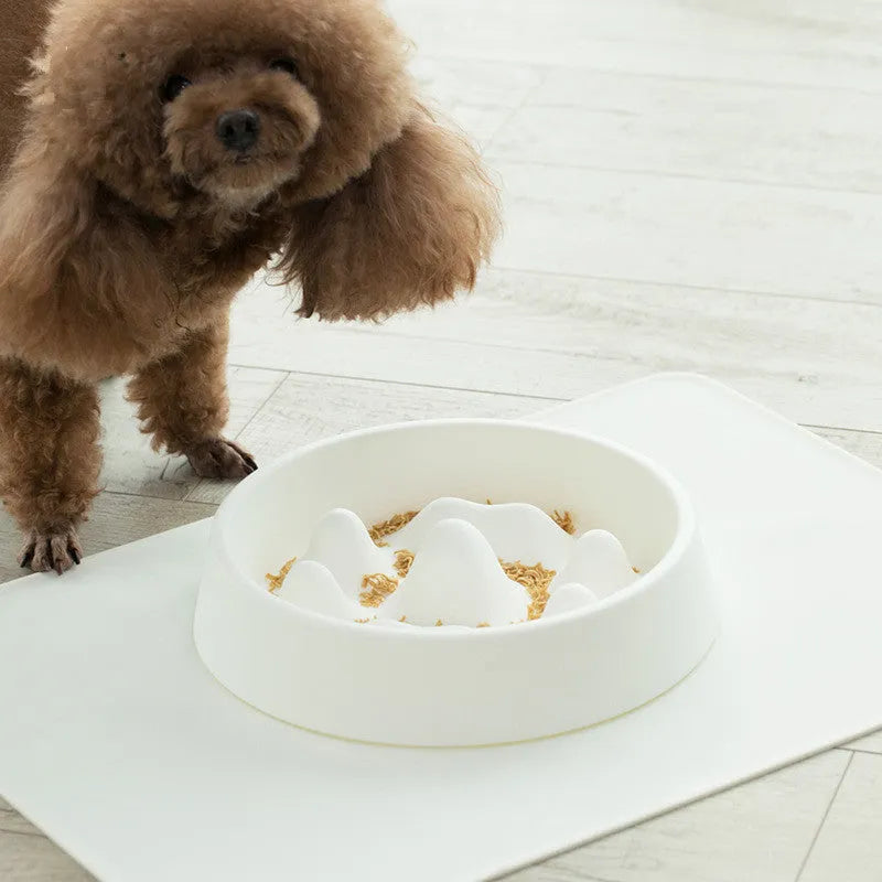 Pet slow food bowl with raised mountain bumps in off-white colour on a floor mat