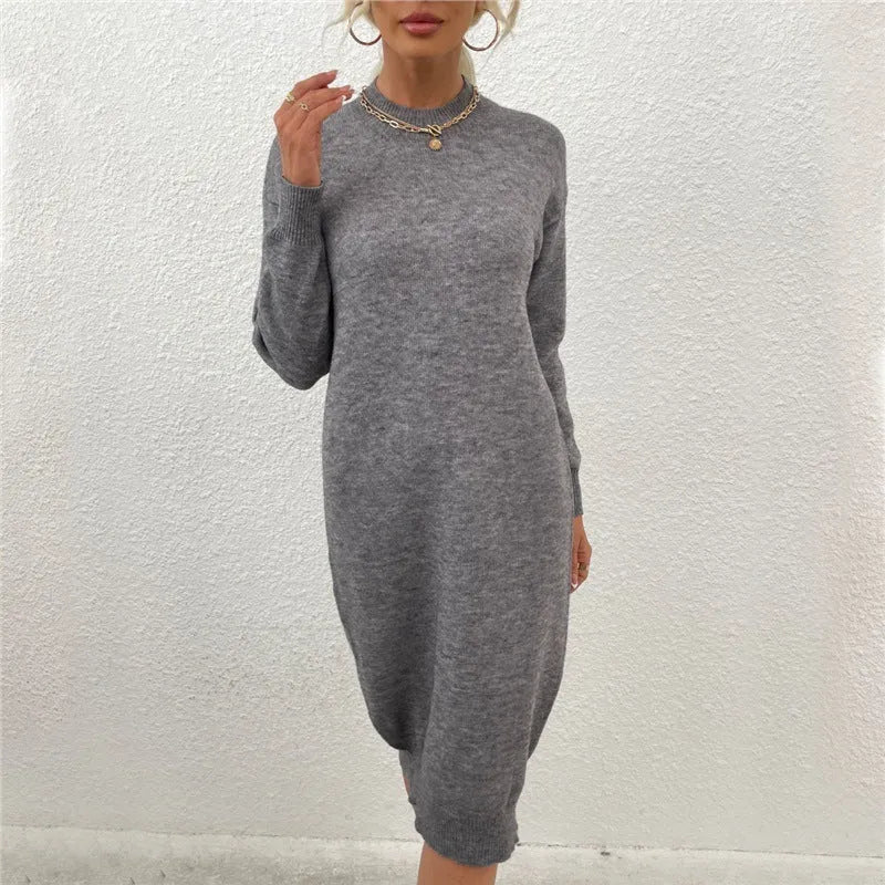 Grey long-sleeved crew neck pullover sweater dress for women on a hanger.