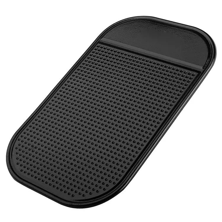 Black silicone car anti slip mat with spider-web texture, 13x7cm, on a car dashboard holding a smartphone