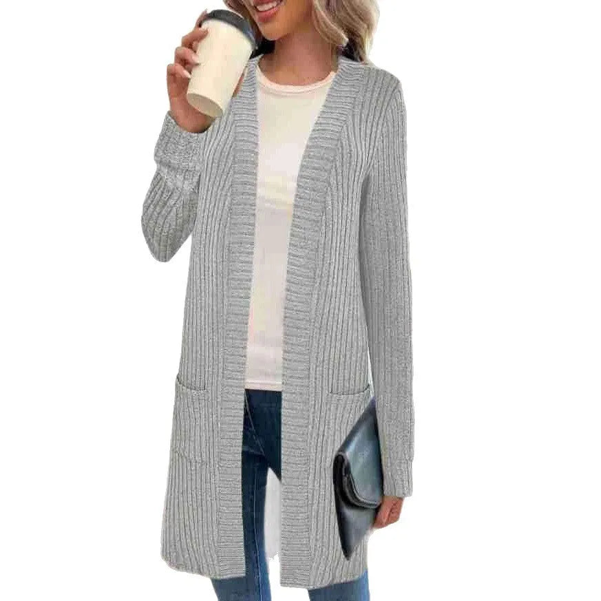 Black oversized knitted cardigan jacket with long sleeves and loose pockets.