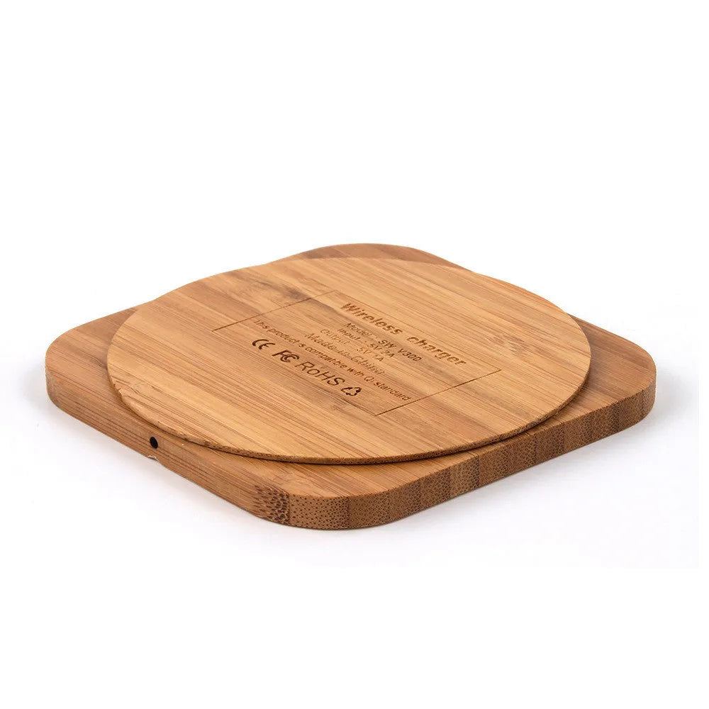 Square brown wooden bamboo wireless charging pad for phones on a desk